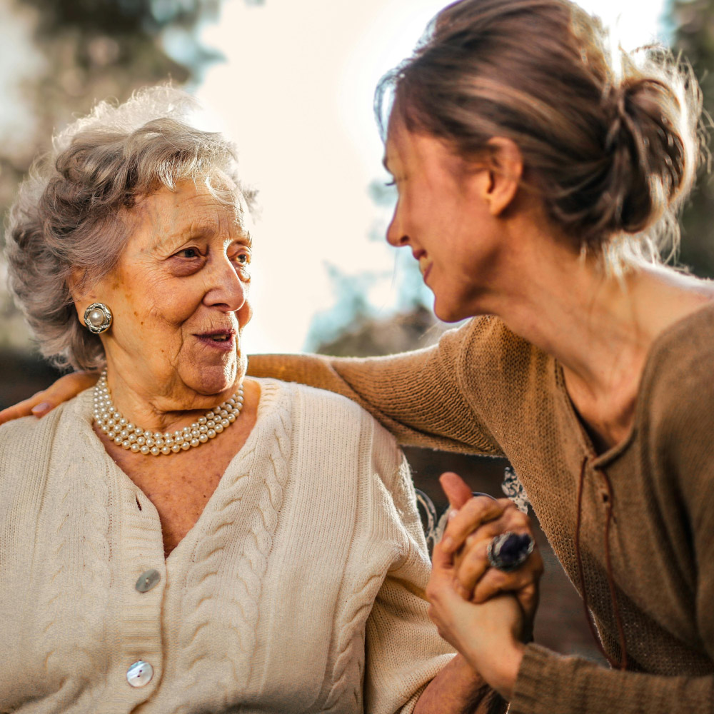 Photo of a caregiver woman and an elderly woman